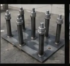 Anchor bolt cage with orange-capped bolts