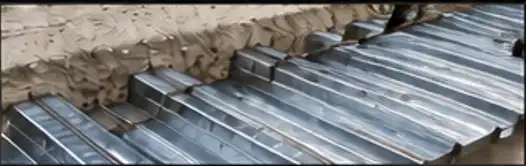 Composite metal floor decking installed over a concrete slab edge