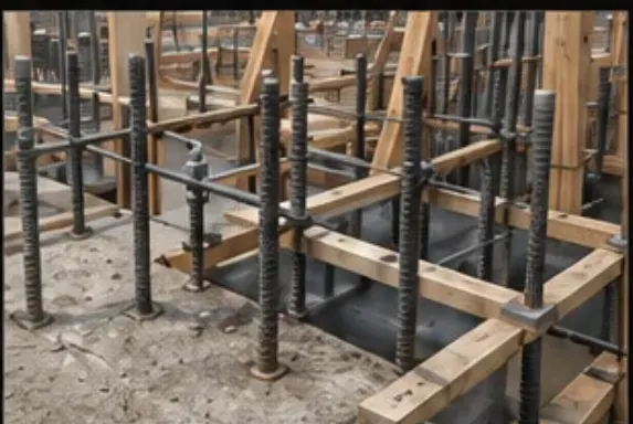 Rebar and anchor bolt embeds set in wooden concrete forms at a job site