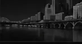 Mid Atlantic city skyline and river at night