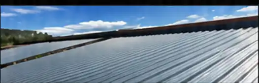 Metal roof decking panels under a blue sky