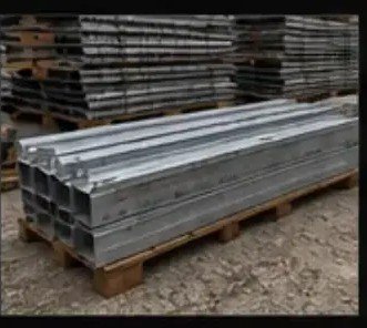 Galvanized lintels stacked on a pallet outdoors